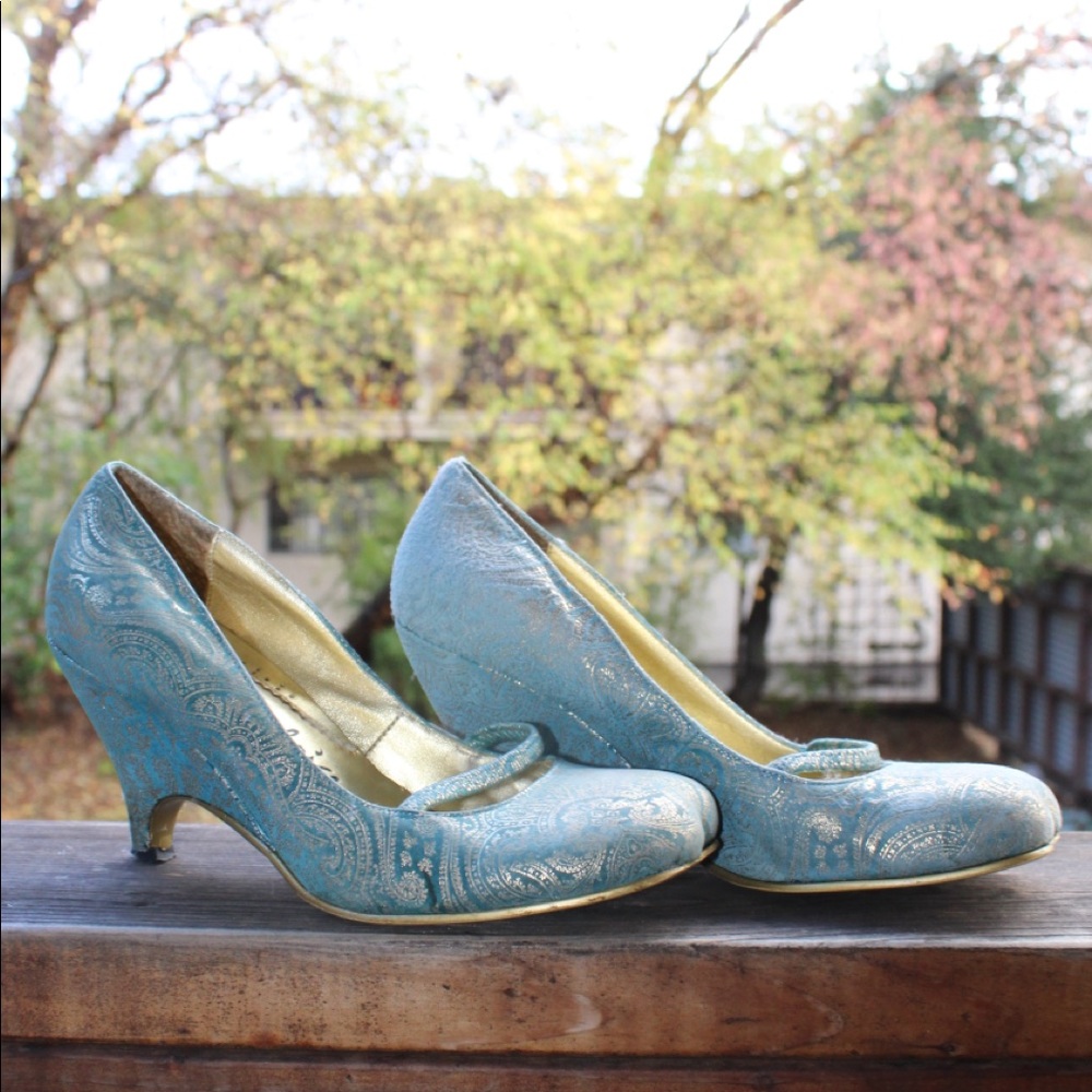 Blue low heels with gold design on it